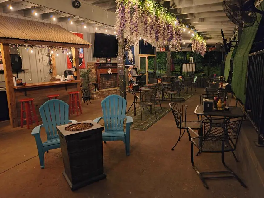 Covered patio with turquoise chairs around a fire pit in Jasper, GA