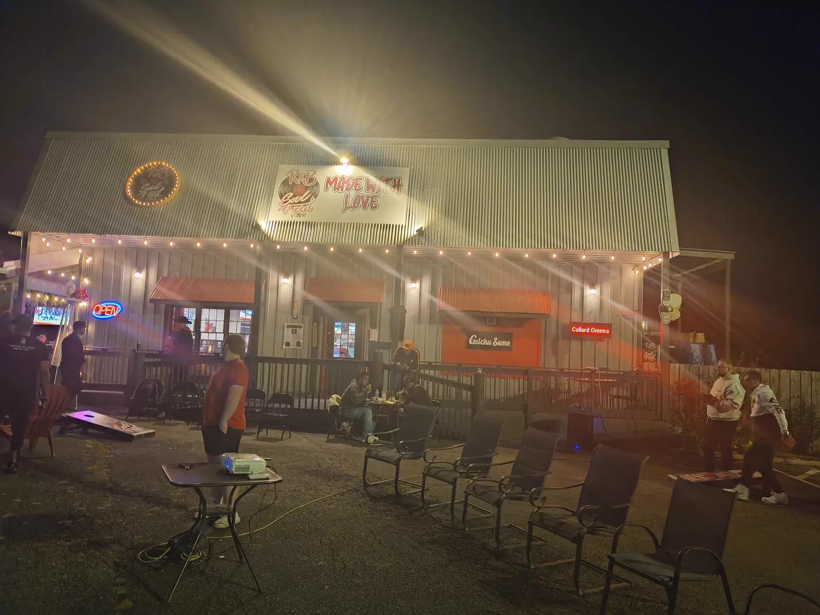 Guests on the porch under string lights at night at R & B Made With Love in Jasper, GA